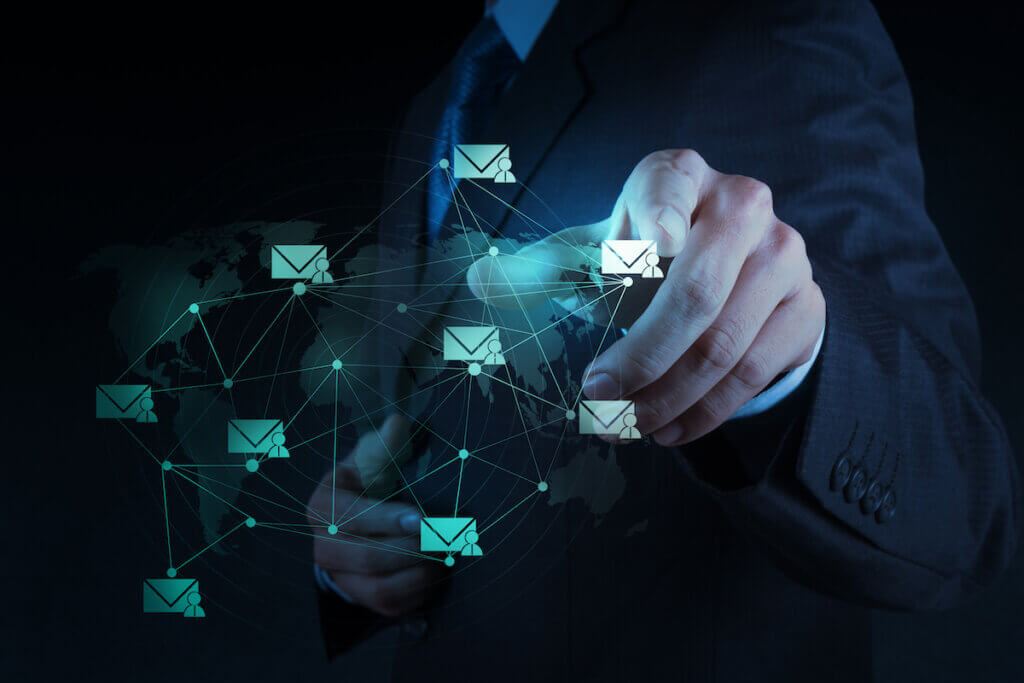 The hand of a man in a suit interacting with a web of newsletters.