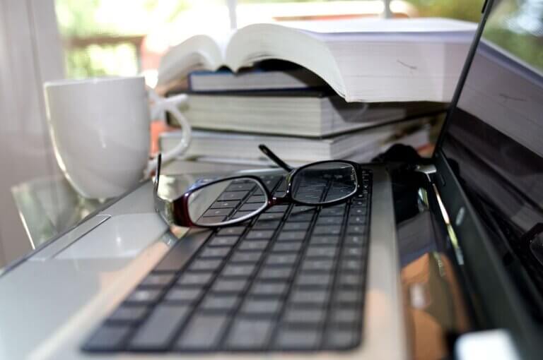 Book stack near laptop
