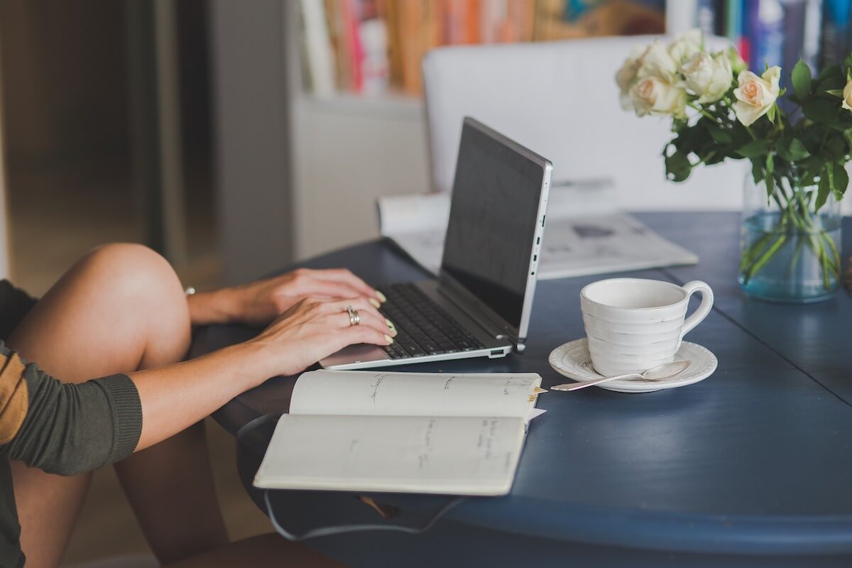 woman writing on a laptop