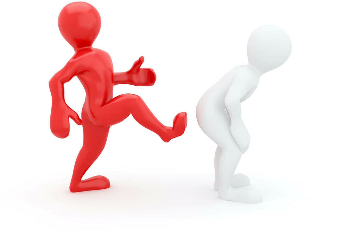 A red figure giving a motivational kick from behind to a white figure.