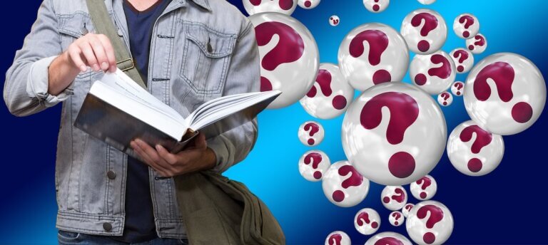 A student holding a book with question mark bubbles behind him.