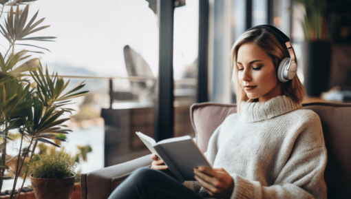 woman-reading-next-to-a-window-with-headphones