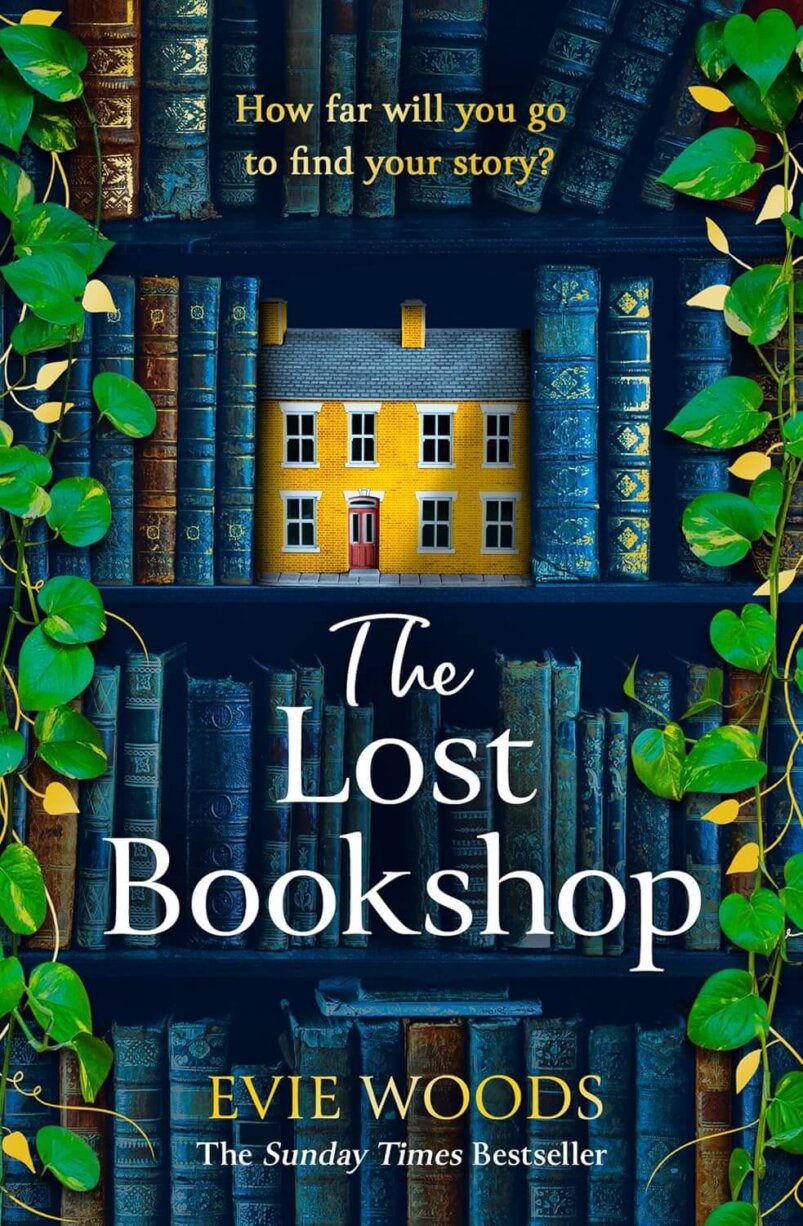 Front cover of "The Lost Bookshop" by Evie Woods, featuring an illustration of a bookshelf covered in vines with a yellow brick building serving as a bookstop on a top shelf.